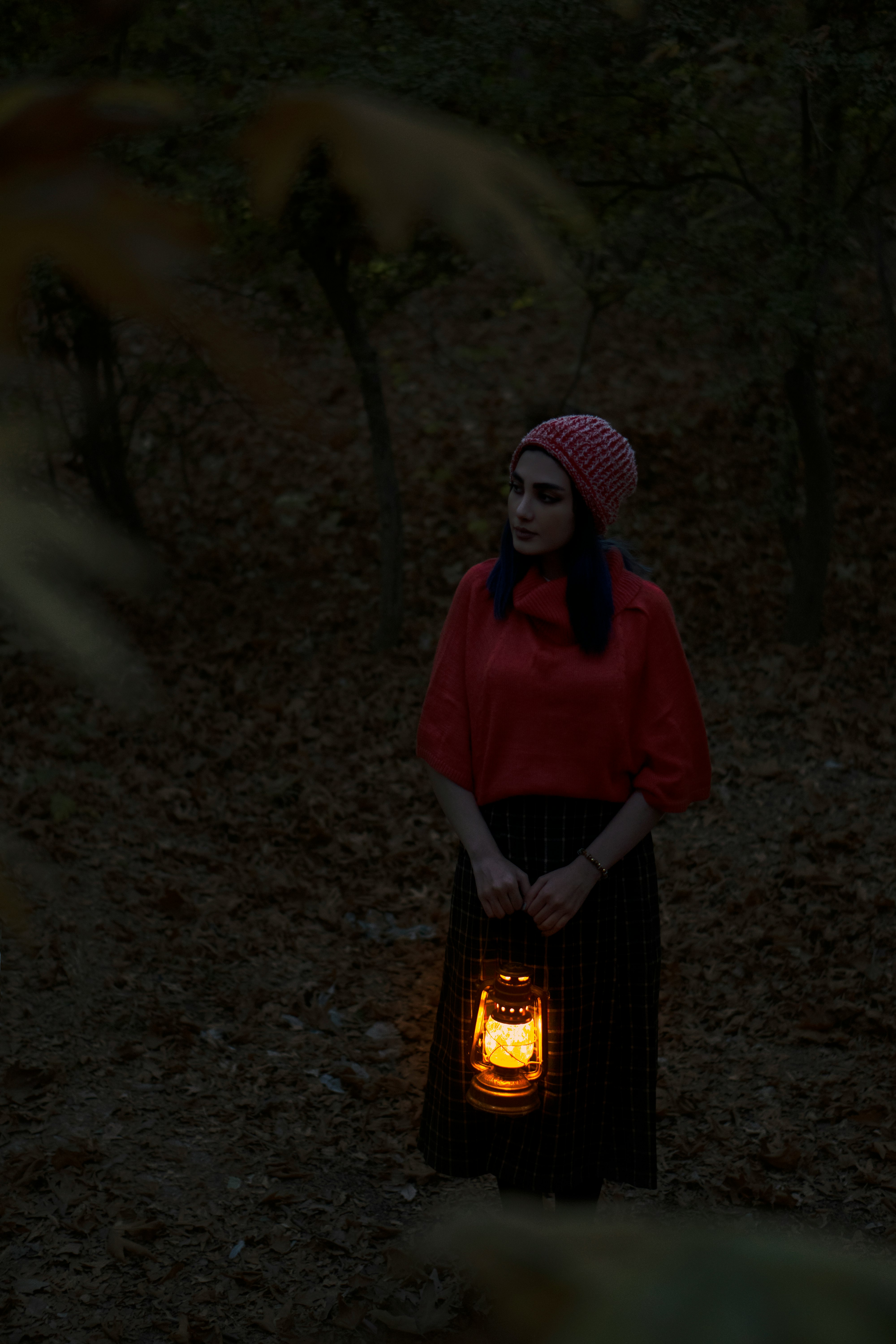 woman in red polo shirt standing in front of fire